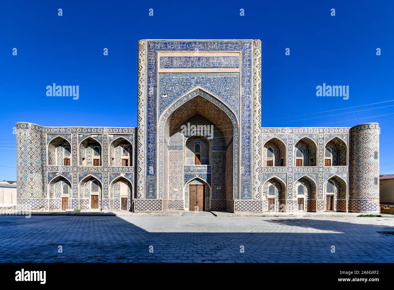 Abdullah Khan madrasa vanta la perfettamente decorato cortile con le mattonelle blu traceries sulle pareti a Bukhara, Uzbekistan. Foto Stock