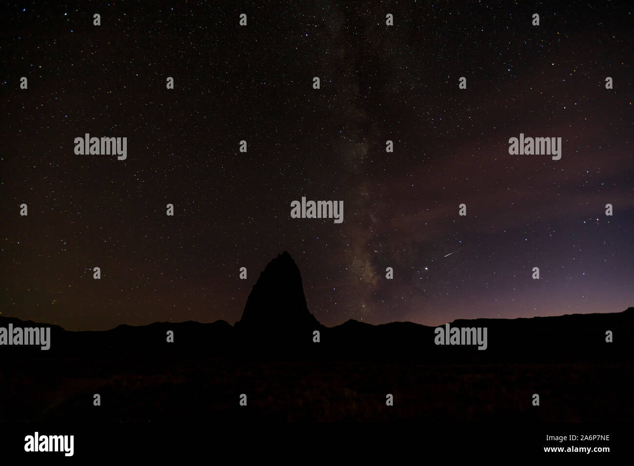 Questa è una vista del cielo notturno con la silhouette di un red rock monolito noto come il Tempio del Sole, nel Parco nazionale di Capitol Reef, Utah, Stati Uniti d'America. Foto Stock