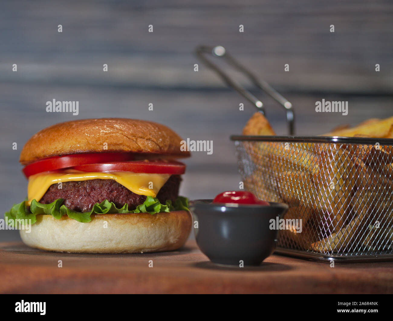 Vegan impianto basato hamburger con patatine fritte e ketchup servita su rustiche vassoio in legno Foto Stock