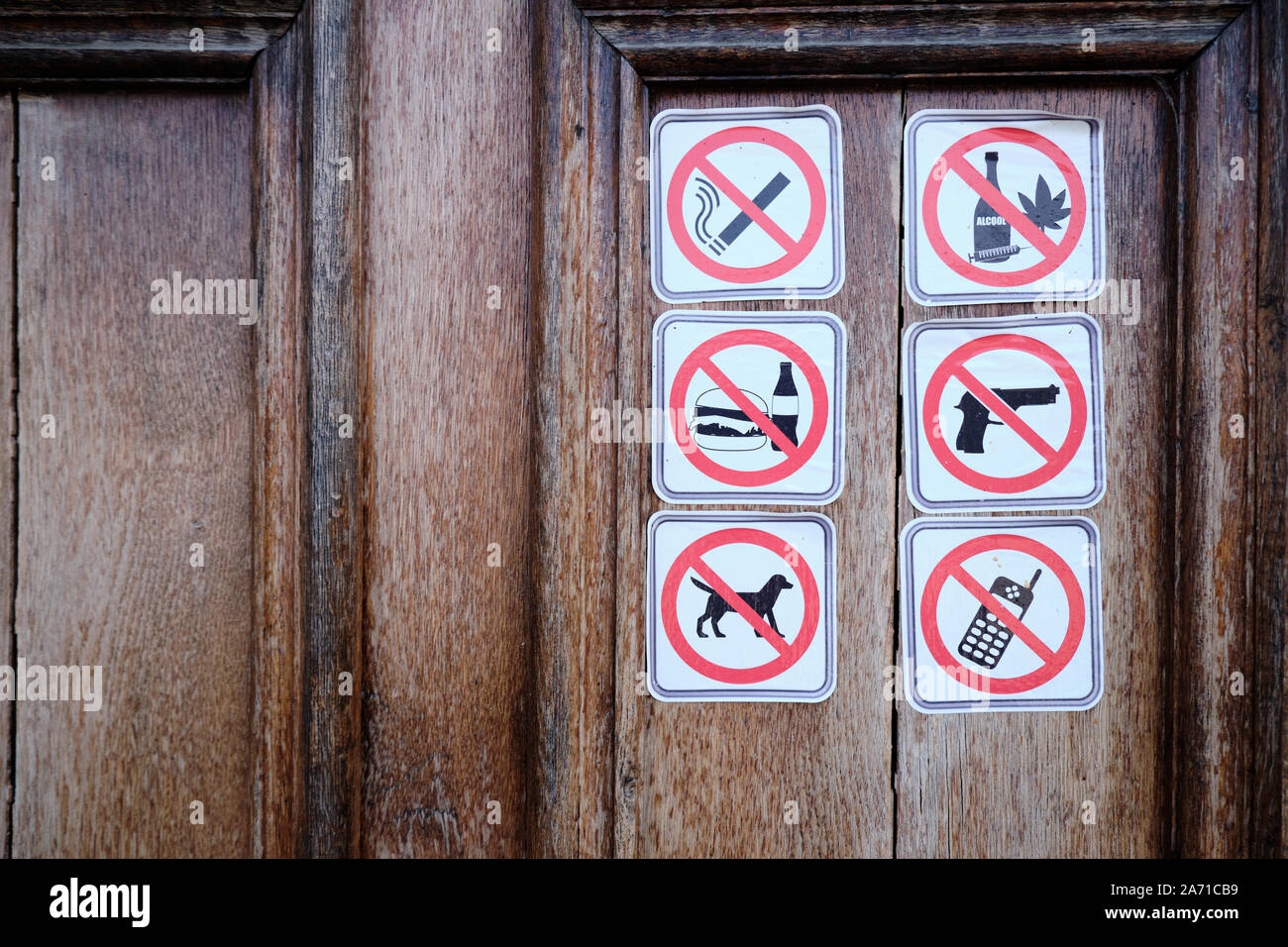 Più vietato segni su una porta di legno: il fumo, farmaci, prodotti alimentari, pistole, animale, mobile Foto Stock