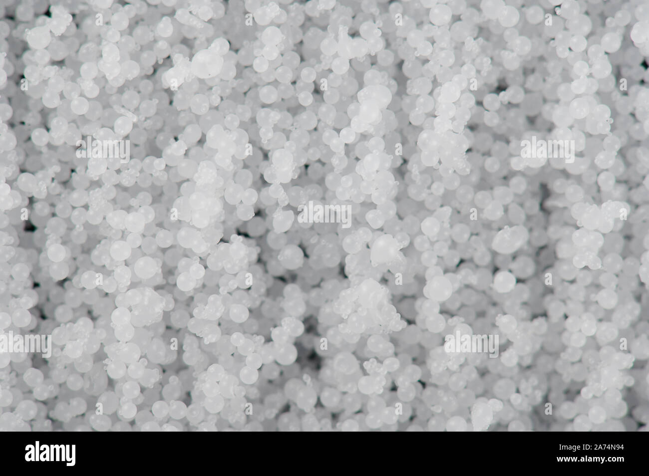 Numerose rotonde palle bianche macro vista ravvicinata. Texture della maglia in plastica Foto Stock