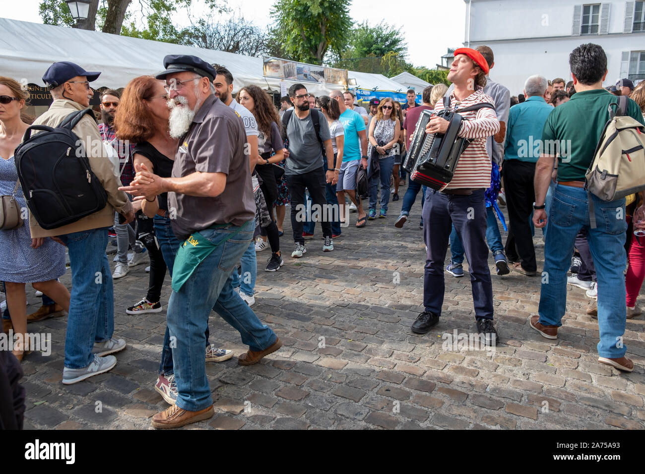Un paio di danze al chansonnier di canzone alla sagra de vendanges sotto il Sacre Coeur a Parigi il quartiere di Montmartre. Foto Stock