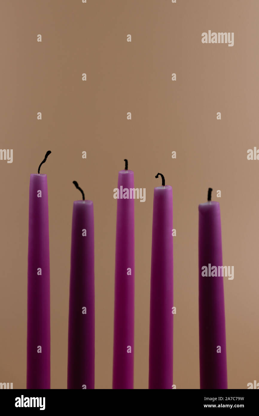 Candele bruciate, isolate su sfondo arancione sbiadito Foto Stock