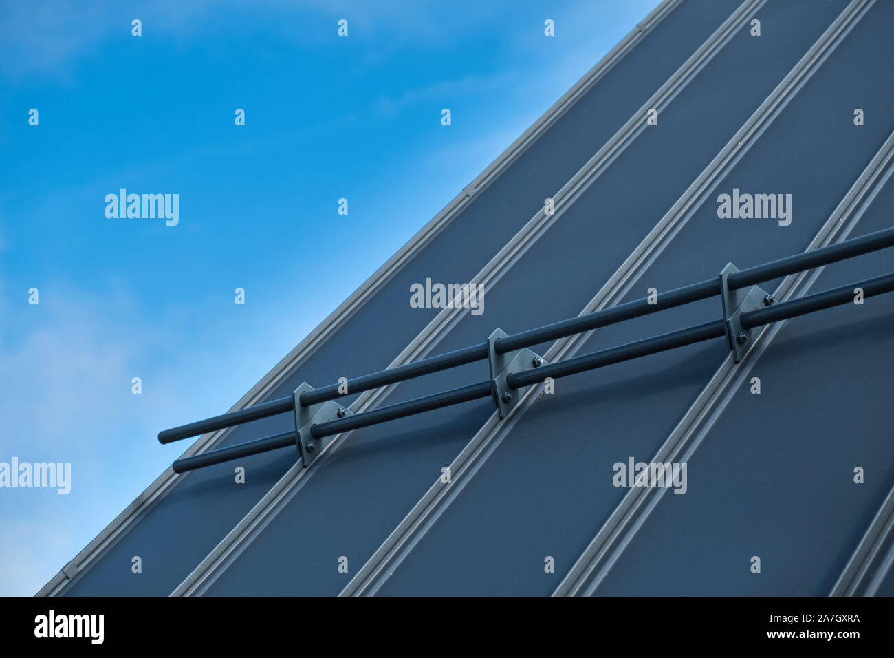 Giunzione permanente tetto metallico e chiudere con le protezioni di neve e cielo blu in background Foto Stock