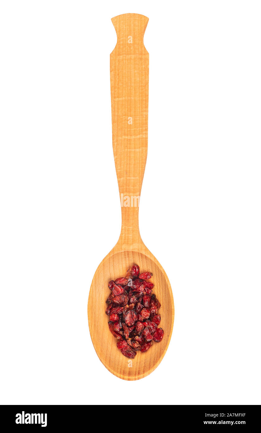 Grande cucchiaio di legno secco con bacche di Crespino su sfondo bianco, vista dall'alto Foto Stock