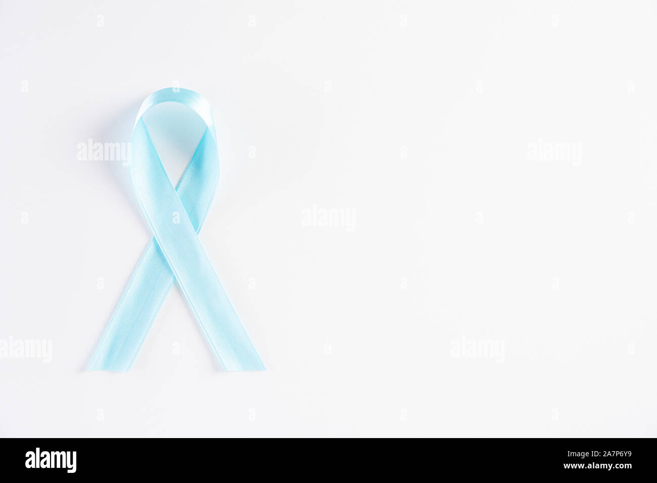 Nastro blu su sfondo bianco che rappresenta un evento annuale durante il mese di novembre per aumentare la consapevolezza degli uomini di problemi di salute della prostata e Annulla Foto Stock
