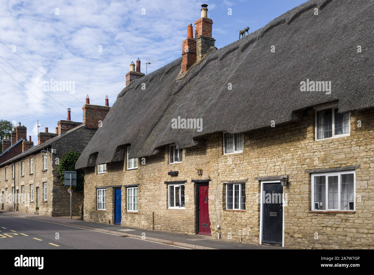 Terrazza della vecchia pietra costruito cottage con il tetto di paglia nel villaggio di Sharnbrook, Bedfordshire, Regno Unito Foto Stock