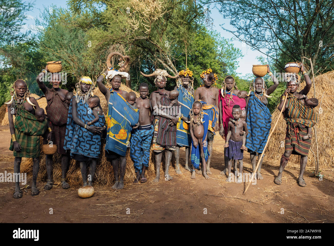 Etiopia, Valle dell'Omo, 6 maggio: gruppo di donne e bambini di più selvagge e pericoloso africano popolo Mursi tribù che vive secondo traditi originale Foto Stock