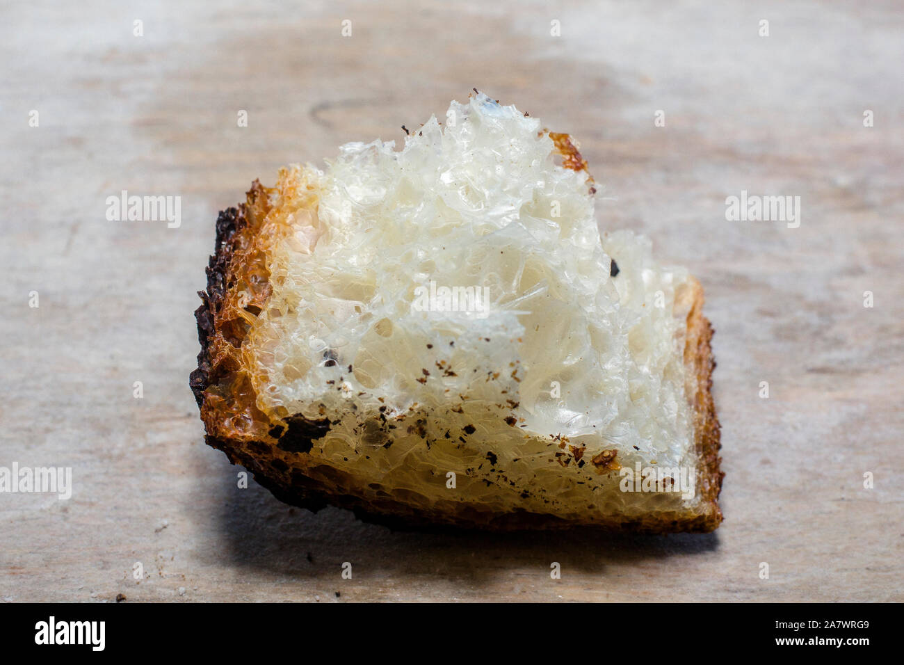 Close-up di un frammento di arioso pane artigianale con crosta caramellati Foto Stock