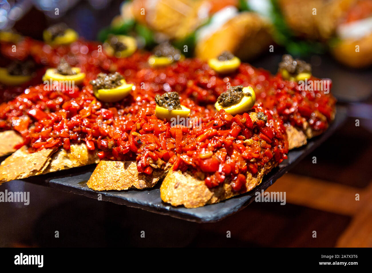 Peperone rosso pintxos con olive presso Atari Gastroteka tapas bar nella città vecchia di San Sebastian, Spagna Foto Stock