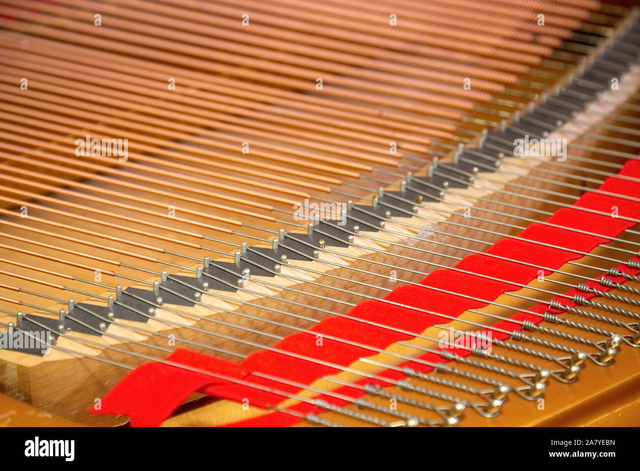 Primo piano di un pianoforte all'interno di stringhe in parallelo in una diagonale di composizione. Foto Stock