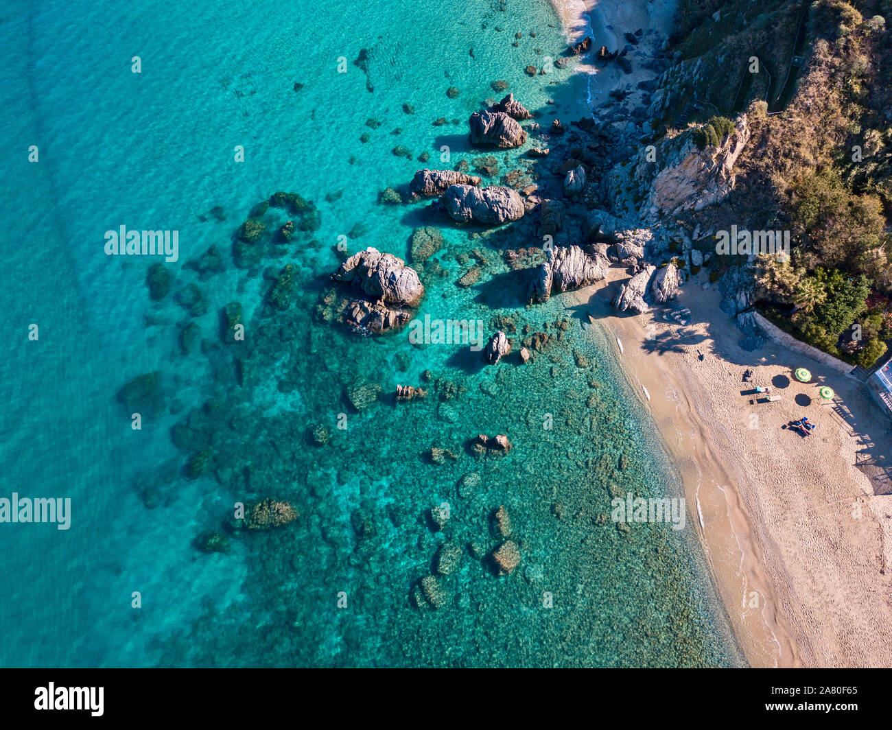 Vista aerea della spiaggia di Tropea, acque cristalline e rocce sulla spiaggia. Calabria, Italia Foto Stock
