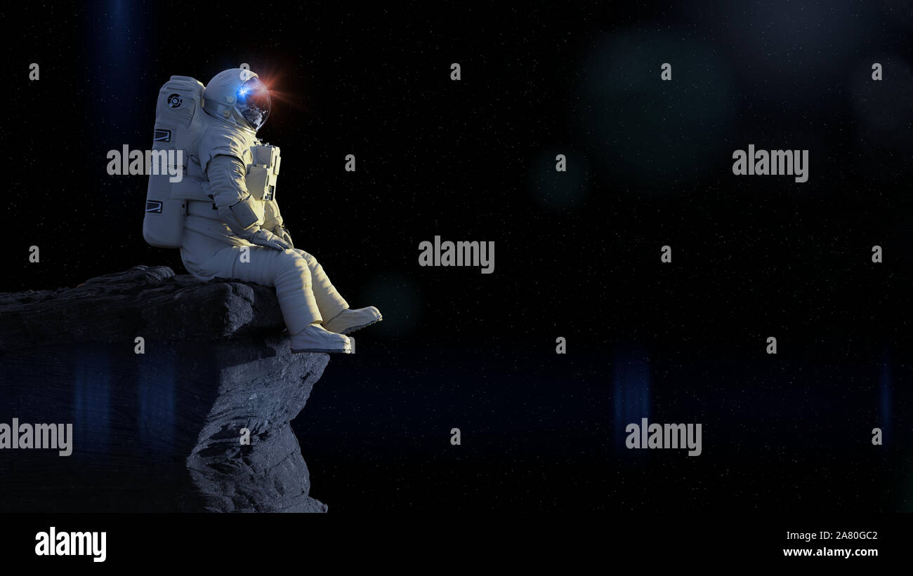 Astronauta seduto su una scogliera godendo la vista su un mondo alieno Foto Stock