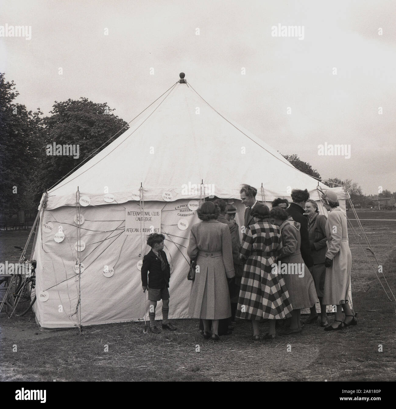 Degli anni Cinquanta, storico visitatori riuniti al di fuori di una mostra tenda dell Africa e arte indiana presentato dal Club Internazionale di Cambridge, Inghilterra, Regno Unito, un club per promuovere gli scambi di studenti. Foto Stock