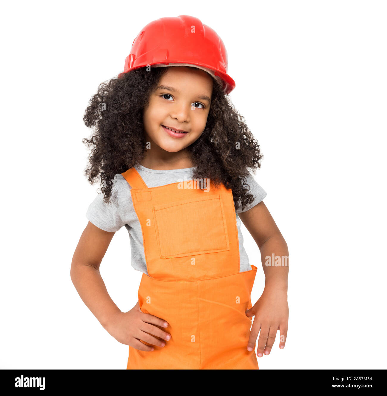 Bambina in arancione repairmen isolato uniforme Foto Stock