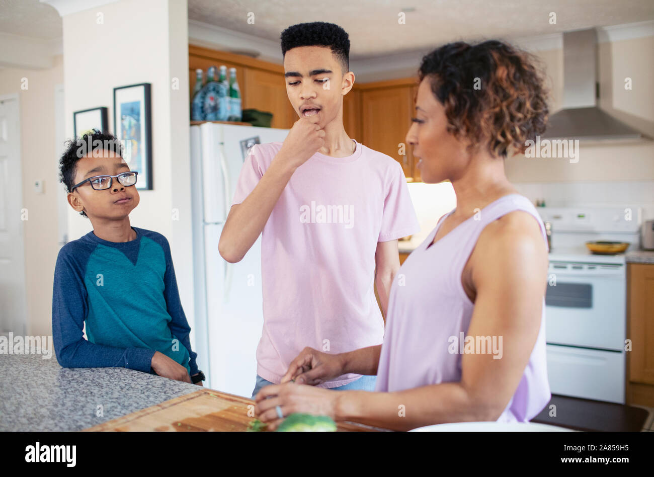 Madre e figli per la cottura in cucina Foto Stock