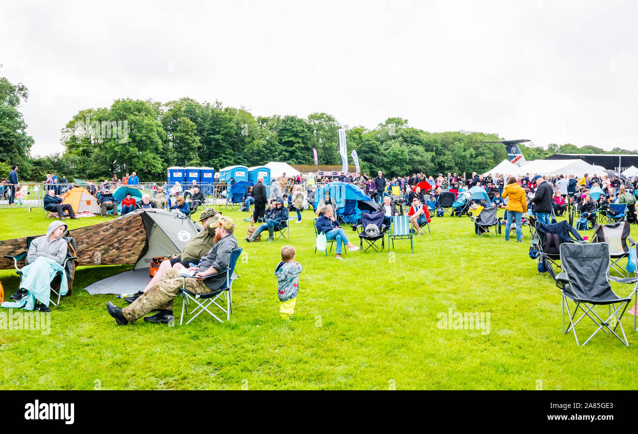 Gli spettatori seduti nel ripiegare su sedie in un giorno di pioggia a livello nazionale, airshow East Fortune, East Lothian, Scozia, Regno Unito Foto Stock