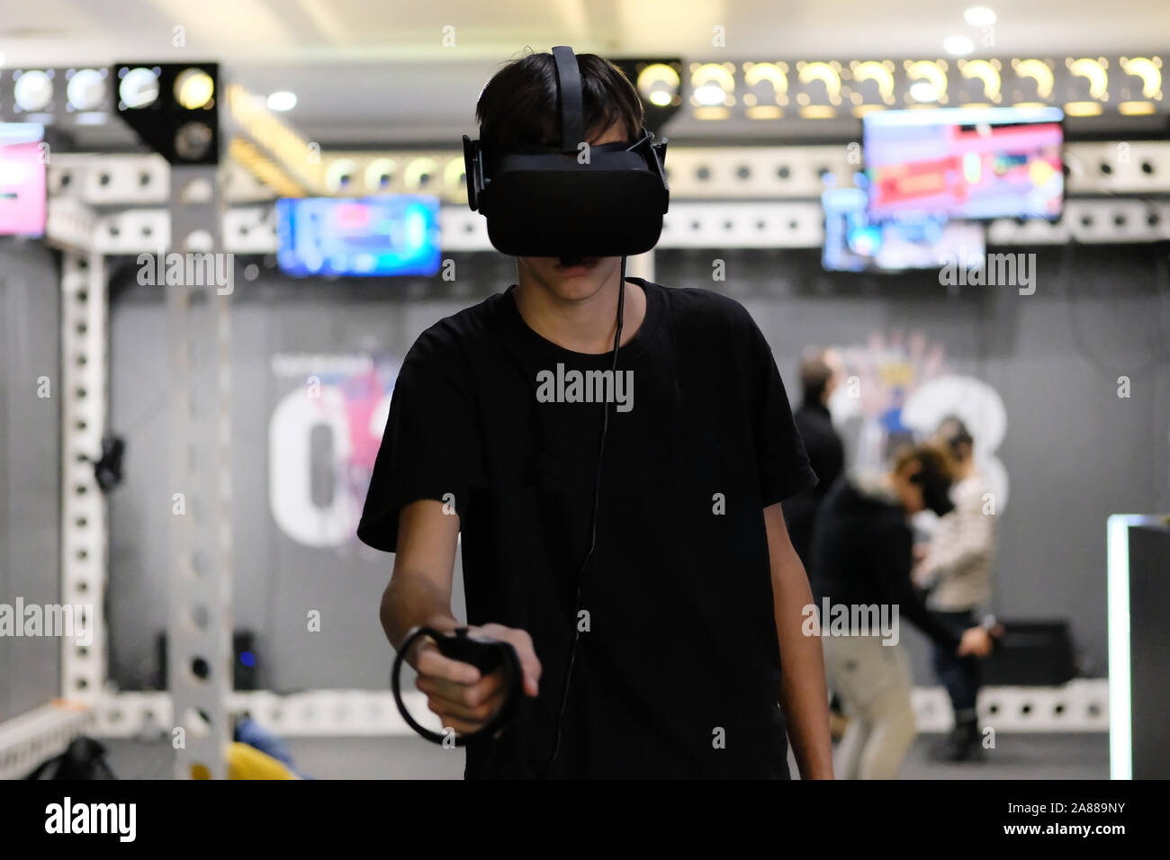 Tecnologia entusiasmante. Adolescente in occhiali per realtà virtuale nella moderna ricerca camera. La tecnologia in ambiente reale. Foto Stock