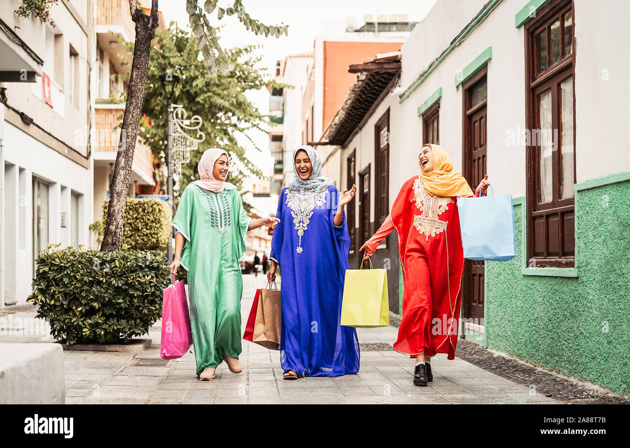 Felici le donne musulmane facendo shopping nel centro città - Arabian teen ragazze divertirsi acquistando nuove tradizionali abiti arabi in mall Foto Stock