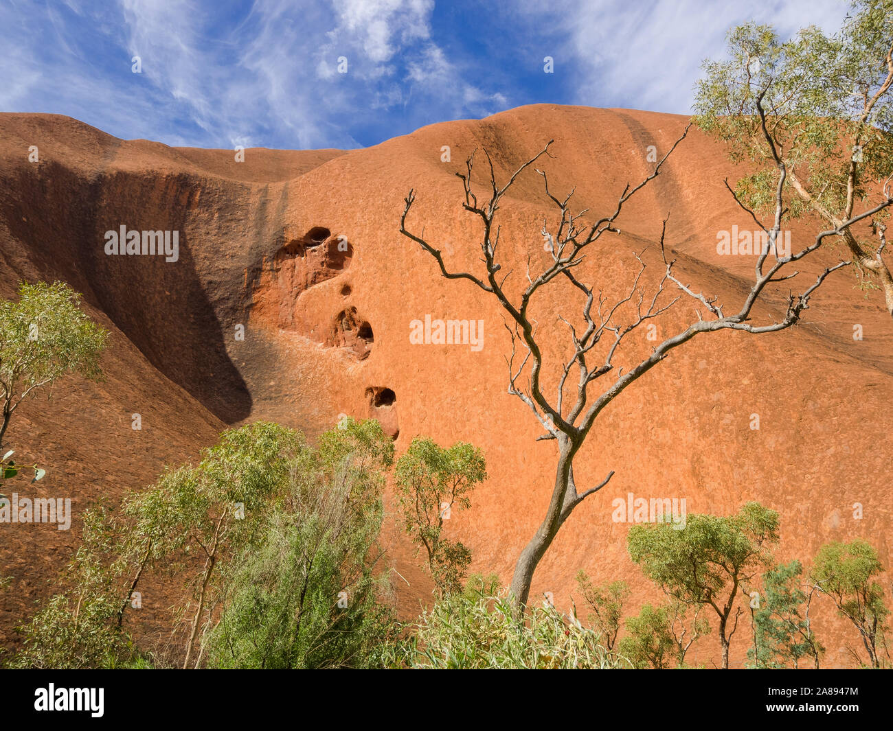 Uluru, o Ayers Rock, è un massiccio monolito di pietra arenaria nel cuore del nord del territorio arido 'Red Centre'. Foto Stock