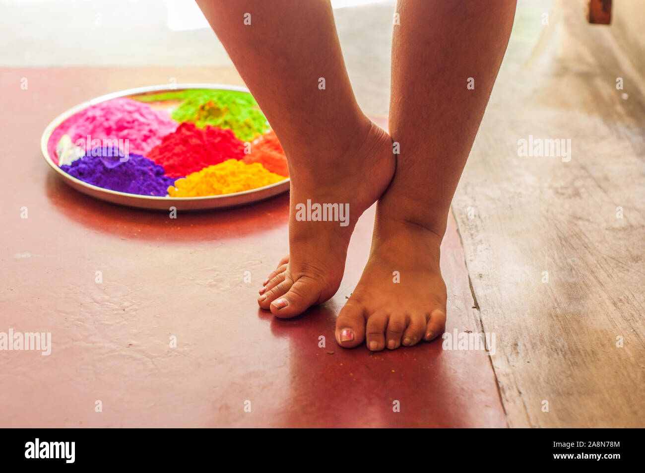 Le gambe di una bambina sul pavimento Foto Stock