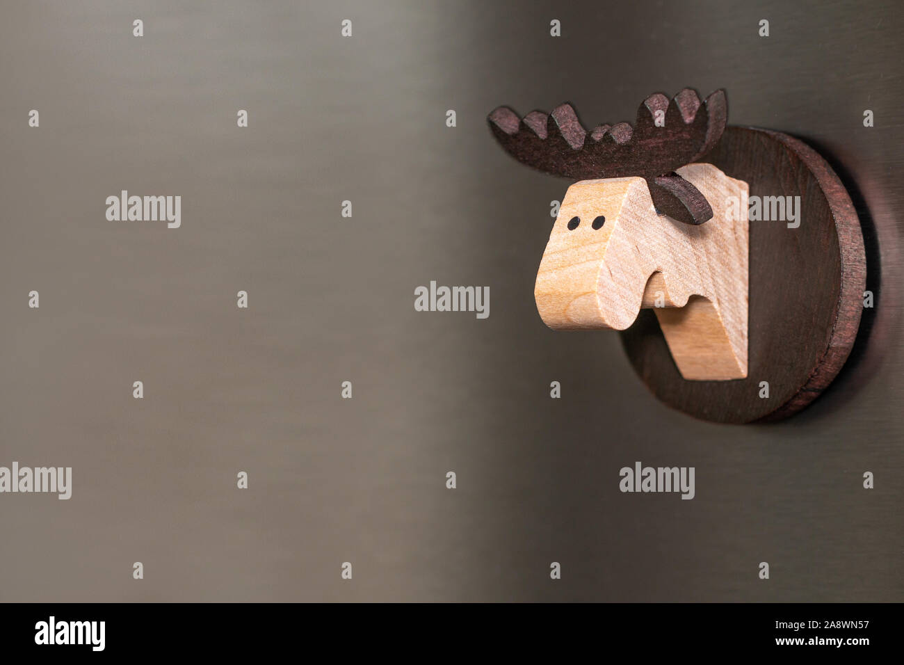 Alci in legno testa magnete tradizionale su un sfondo di acciaio Foto Stock