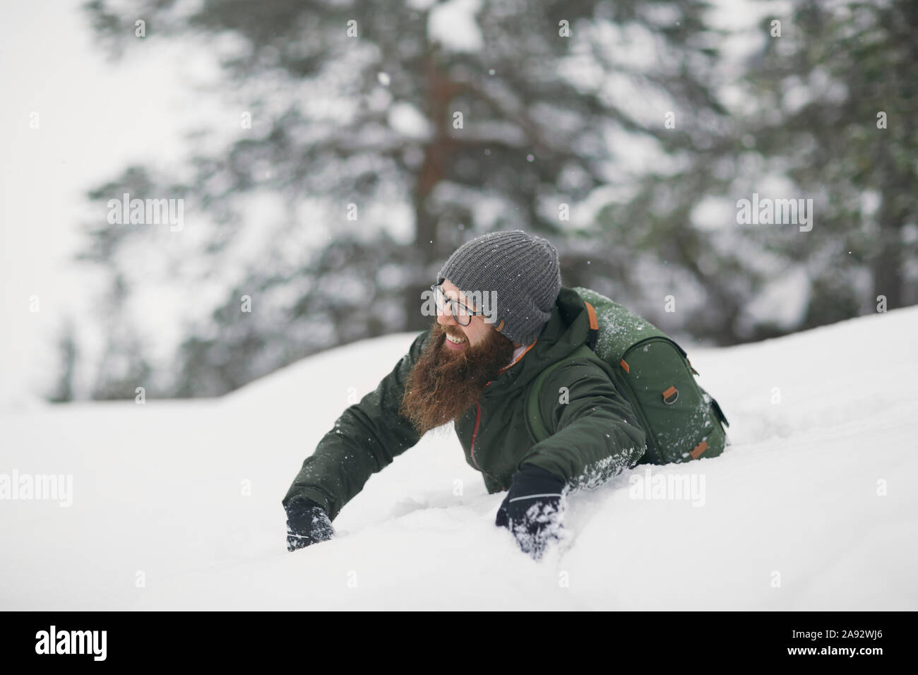 Uomo a giocare nella neve Foto Stock