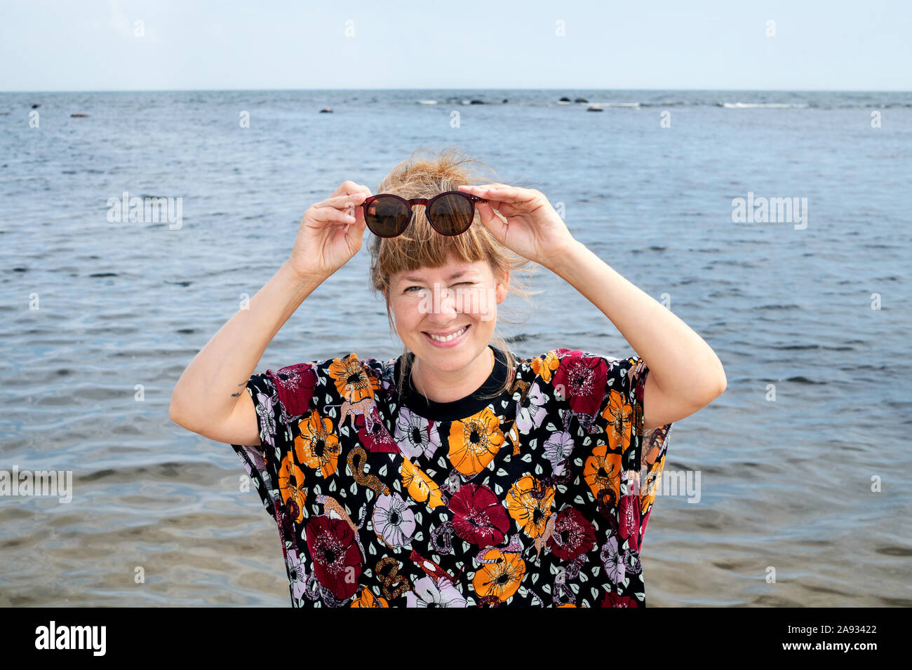 Donna sorridente al mare Foto Stock