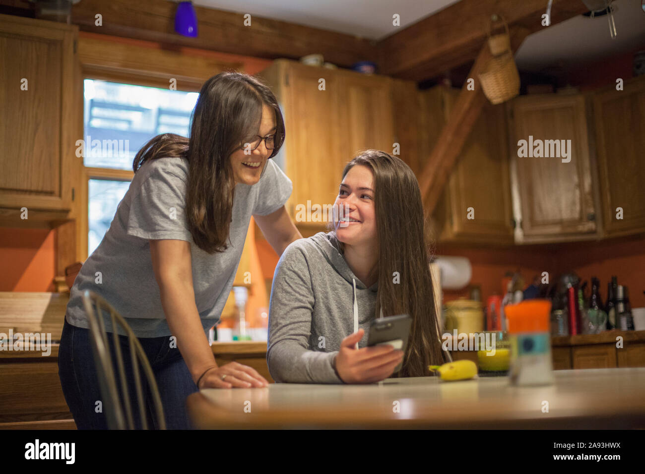 Donna con sclerosi multipla che parla con sua figlia di a. messaggio di testo sul telefono Foto Stock