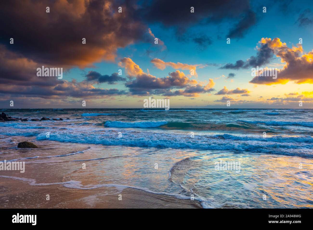 Alba sulla spiaggia e sull'oceano con marea che si diletta sulla sabbia; Kauai, Hawaii, Stati Uniti d'America Foto Stock