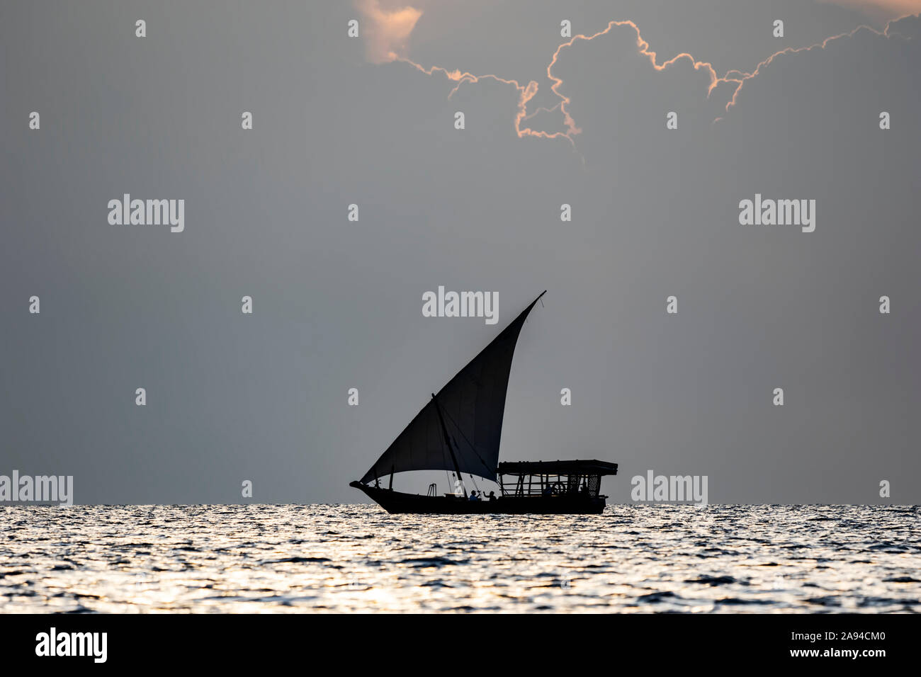 Dhow sull'Oceano Indiano al tramonto; Zanzibar City, Unguja Island, Zanzibar, Tanzania Foto Stock