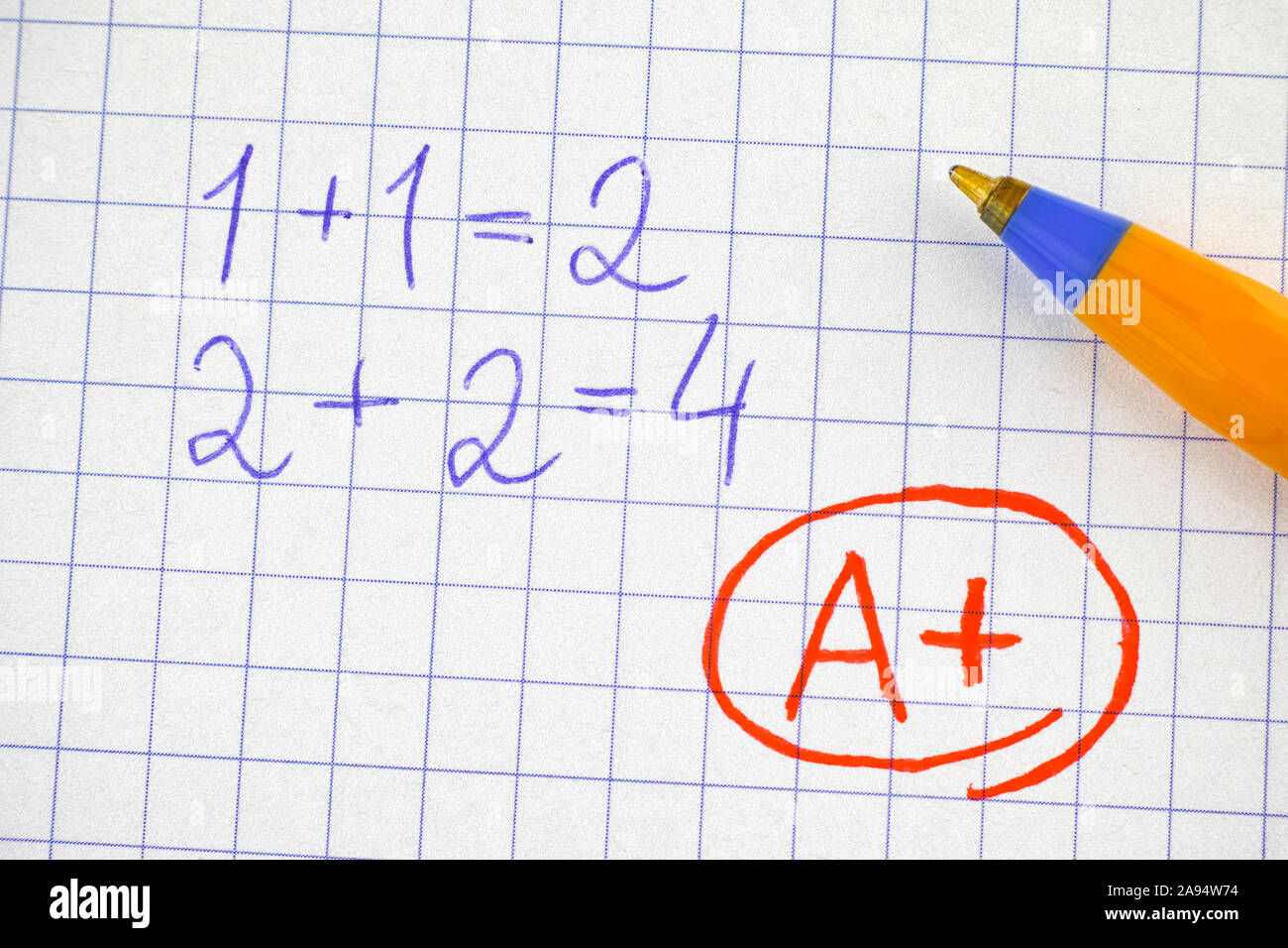 Un plus (A+) grade su notebook foglio di carta con operazioni matematiche risolto. Close up. Foto Stock