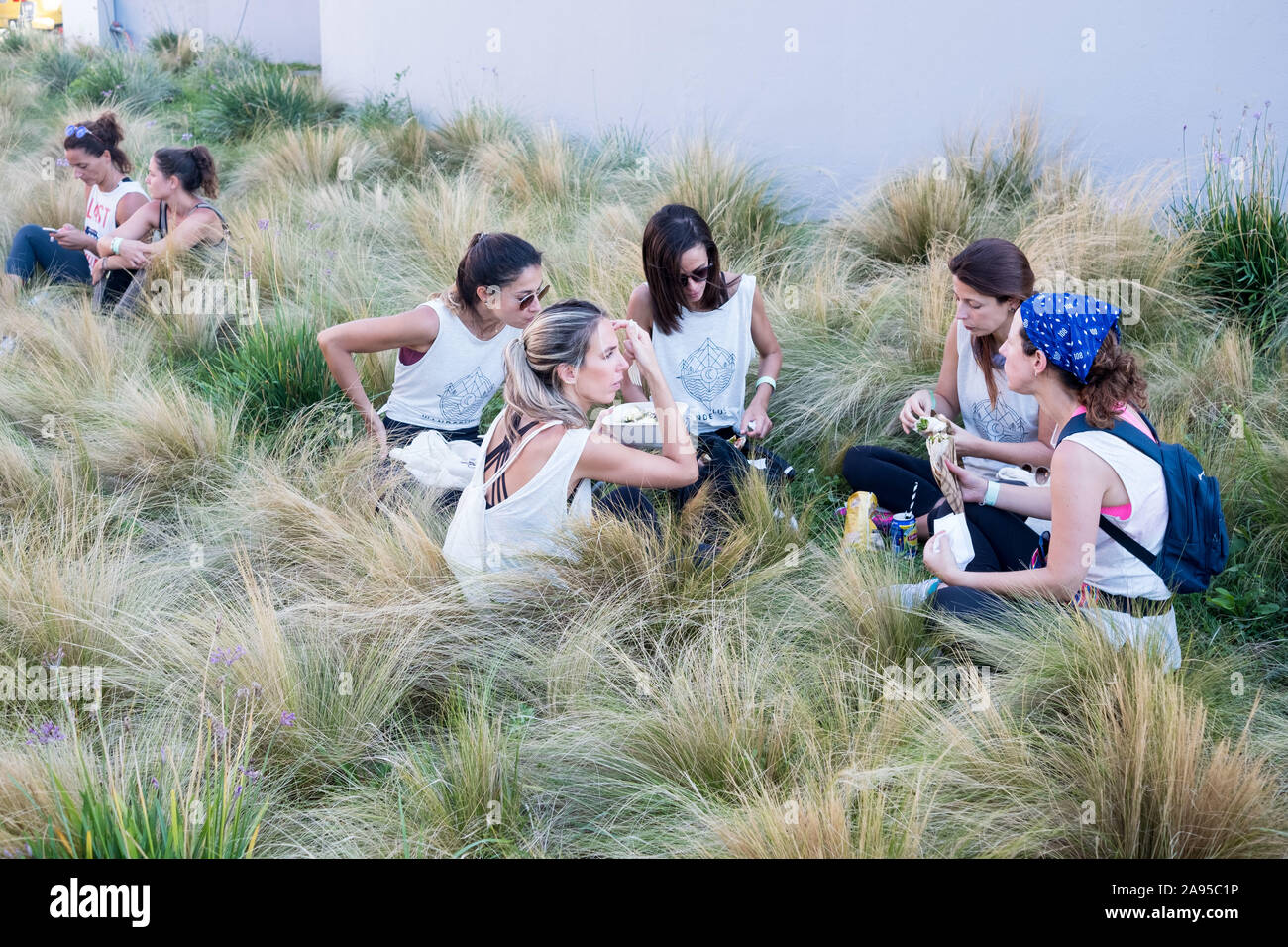 Le donne siedono insieme godendo un picnic al Wanderlust festival, a Lisbona, Portogallo. Foto Stock