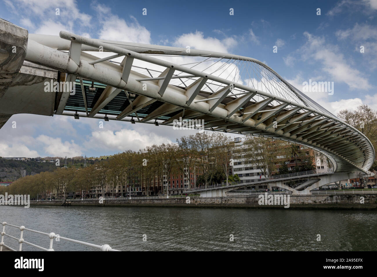 Il Puente Zubizuri, progettato da Santiago Calatrava, un ponte pedonale sopra il fiume Nervión con un avveniristico legato-arch design & una passerella curvi Foto Stock