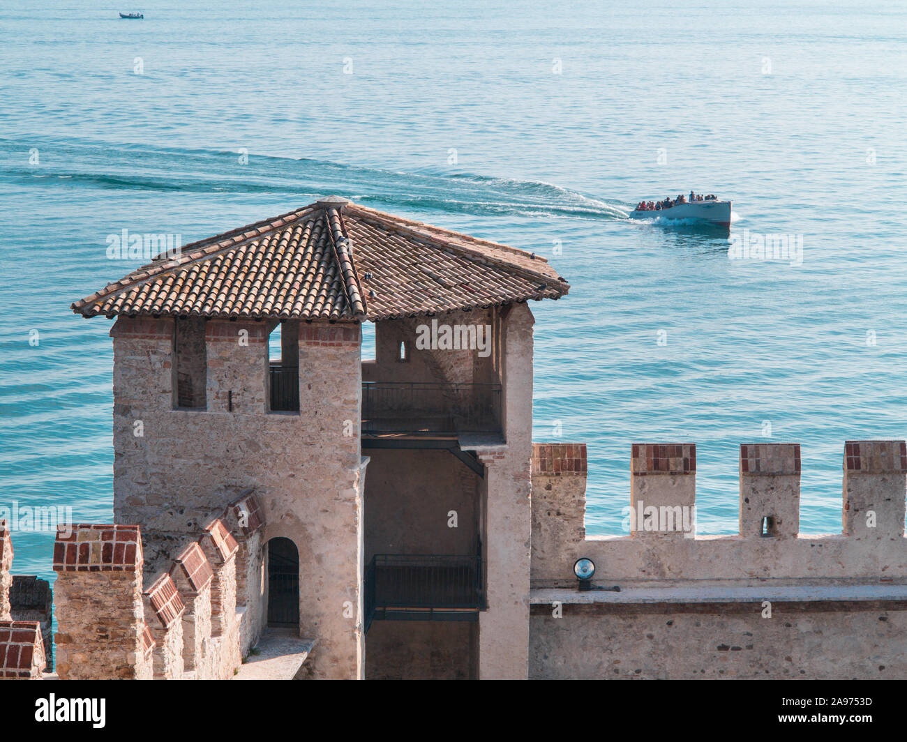 Lago di Garda, il castello di Sirmione e barca sul lago Foto Stock