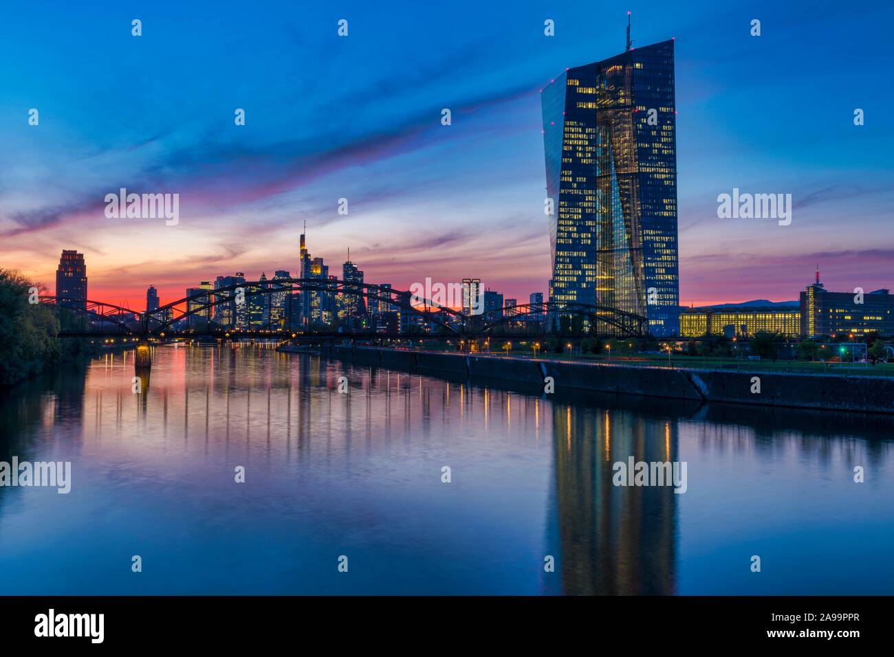 Banca centrale europea (BCE) e dello skyline di Francoforte davanti al tramonto, grattacieli illuminati e riflessi nelle principali, Frankfurt am Main, Hesse Foto Stock
