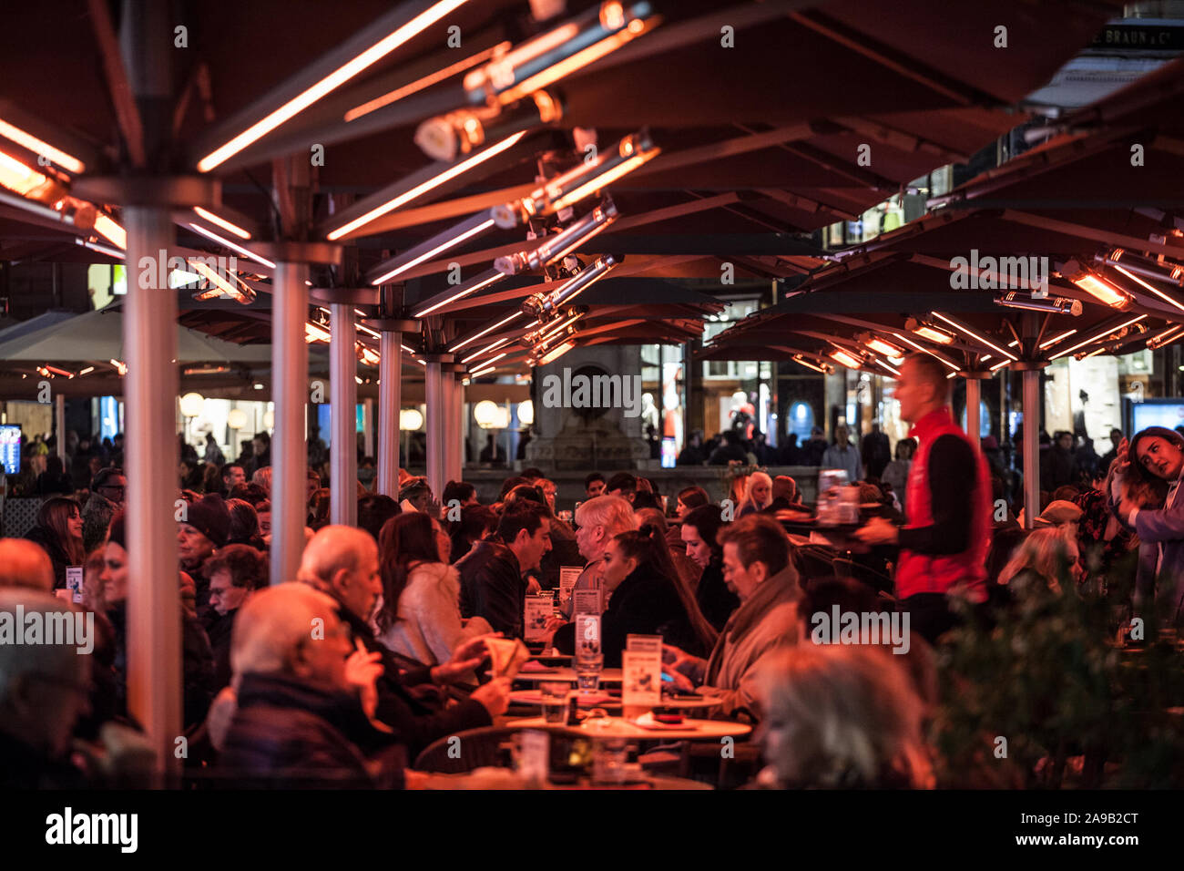 VIENNA, Austria - 6 Novembre 2019: folla di persone di sedersi nella  terrazza di un bar di Vienna Cafe, essendo riscaldata in inverno con  riscaldamento elettrico prod Foto stock - Alamy