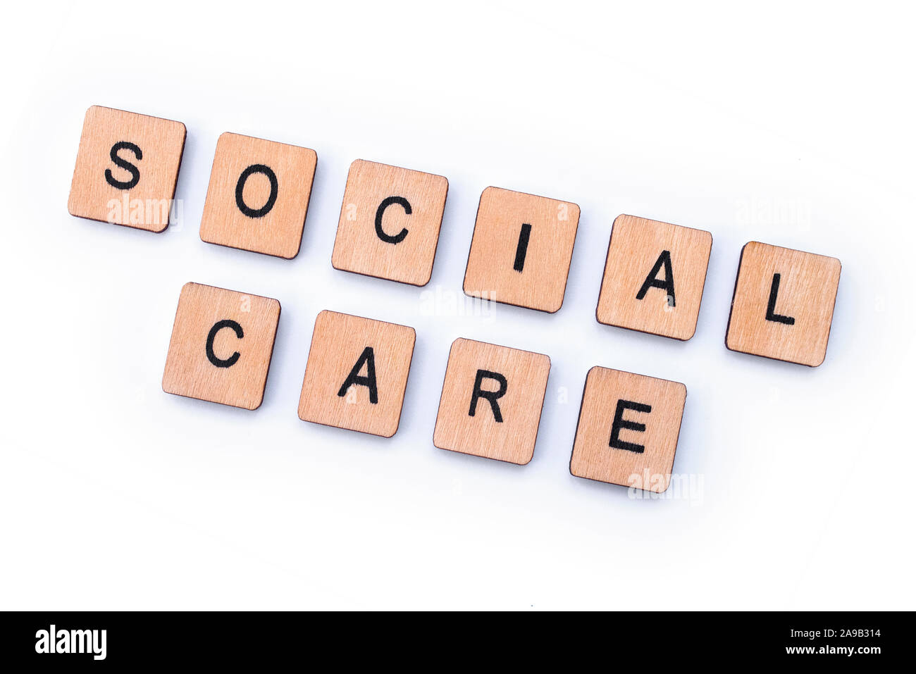 Assistenza sociale, farro con lettera in legno piastrelle. Foto Stock