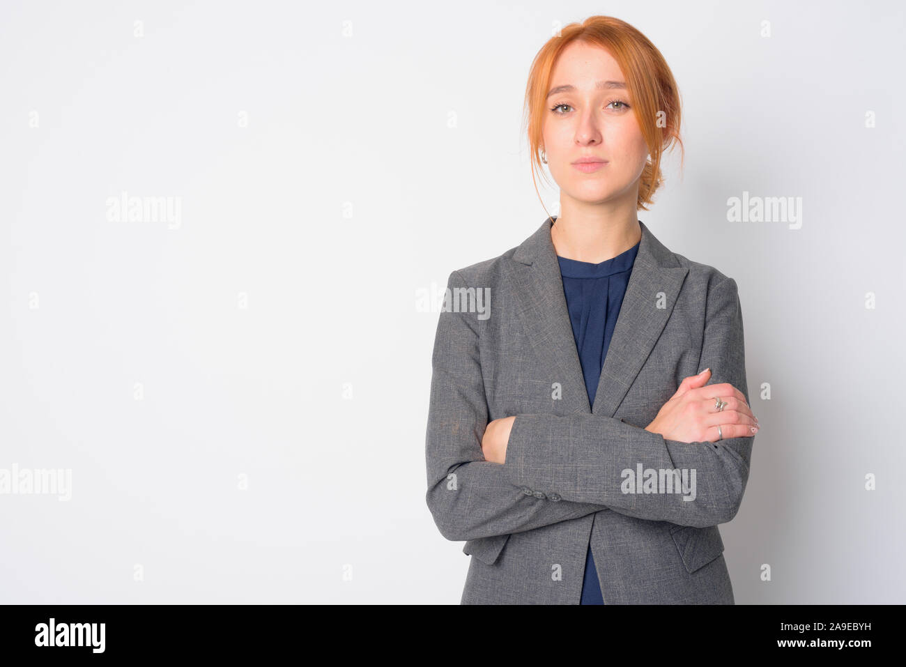 Ritratto di giovane bella redhead imprenditrice con le braccia incrociate Foto Stock