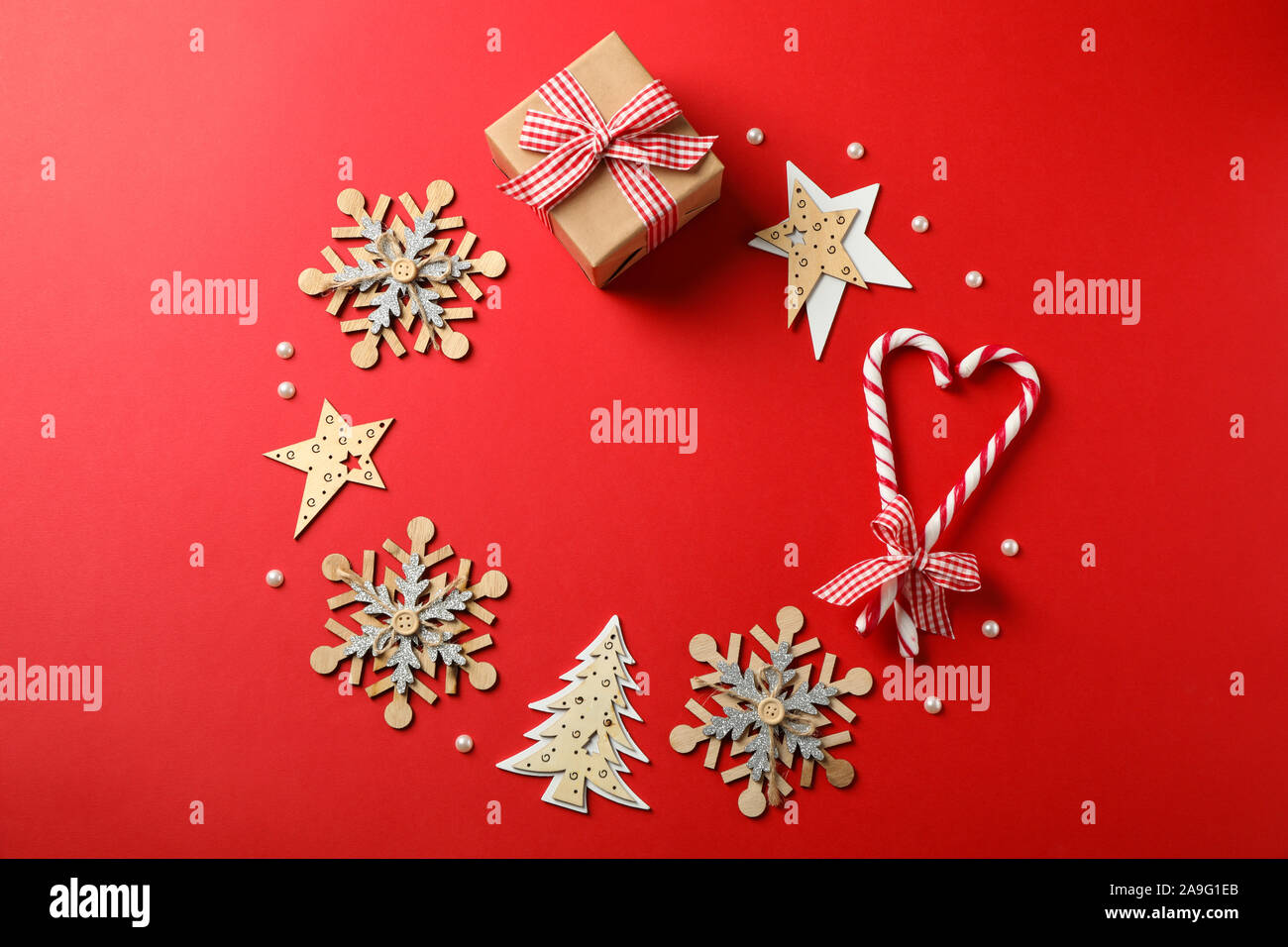 Candy canne e accessori di natale su sfondo rosso, lo spazio per il testo Foto Stock