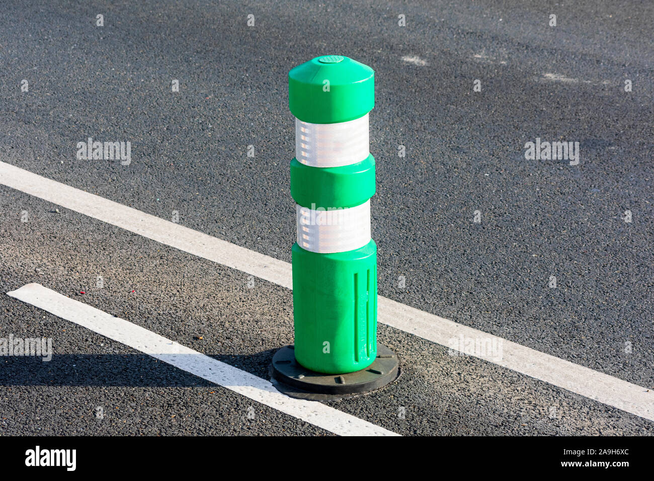 Green post installato su protected bikeway, bike lane o rotta Foto Stock