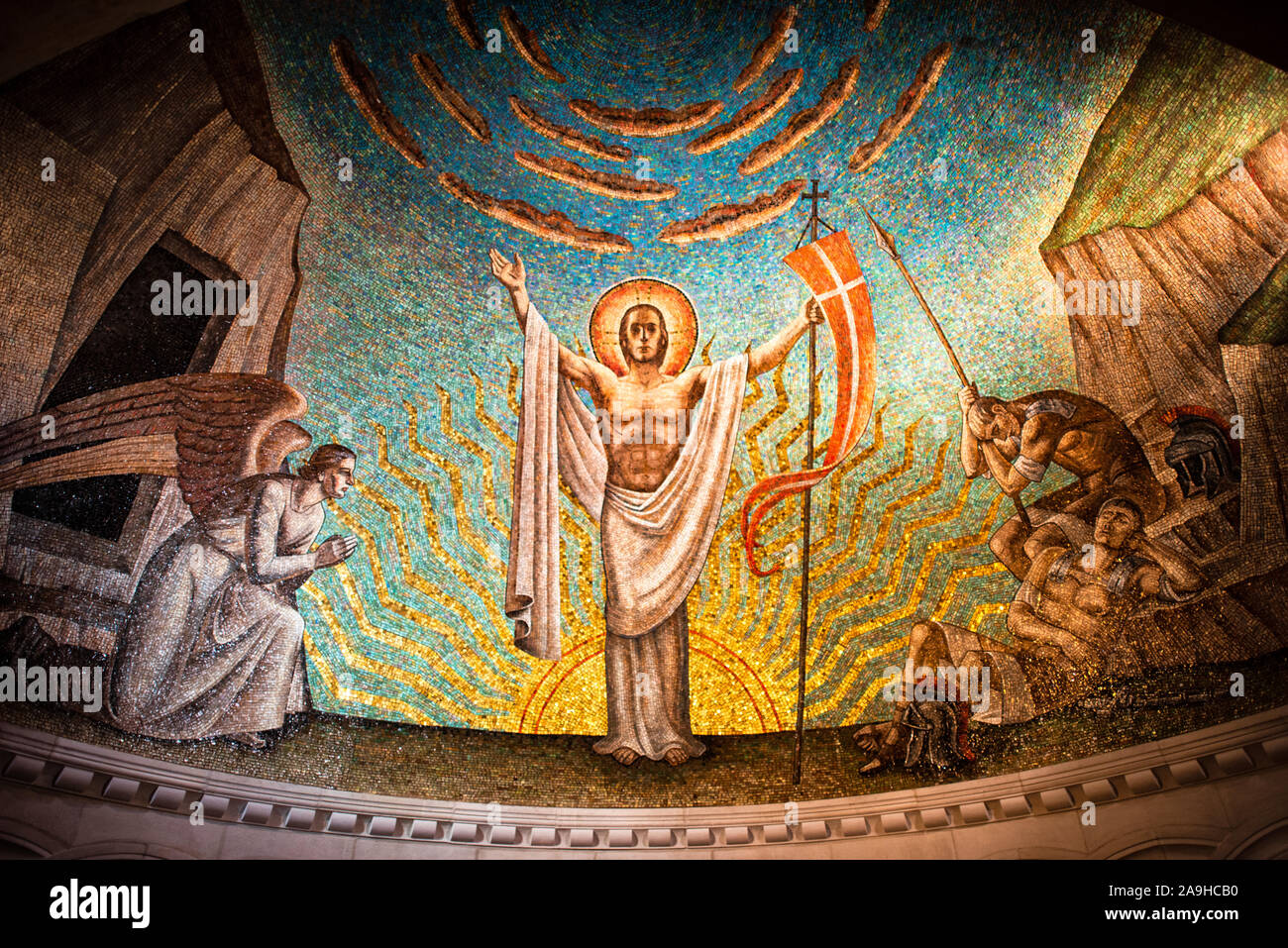 WASHINGTON, DC -- un mosaico absidale di Philip Frohman chiamato Resurrection (1951) nella Cappella della Resurrezione nella Cattedrale Nazionale di Washington DC. Il mosaico è realizzato con piccole tessere di vetro colorate ed è stato eseguito dai mosaici di Ravenna. La Cappella della Risurrezione è una delle cappelle della cripta sotto la Cattedrale Nazionale. La Washington National Cathedral è una chiesa episcopale situata a Washington DC ed è il luogo di molte delle principali chiese e dei servizi di ricordo di Washington DC. Progettata in stile neogotico, la sua costruzione è iniziata nel 1906, con lavori che proseguono o Foto Stock