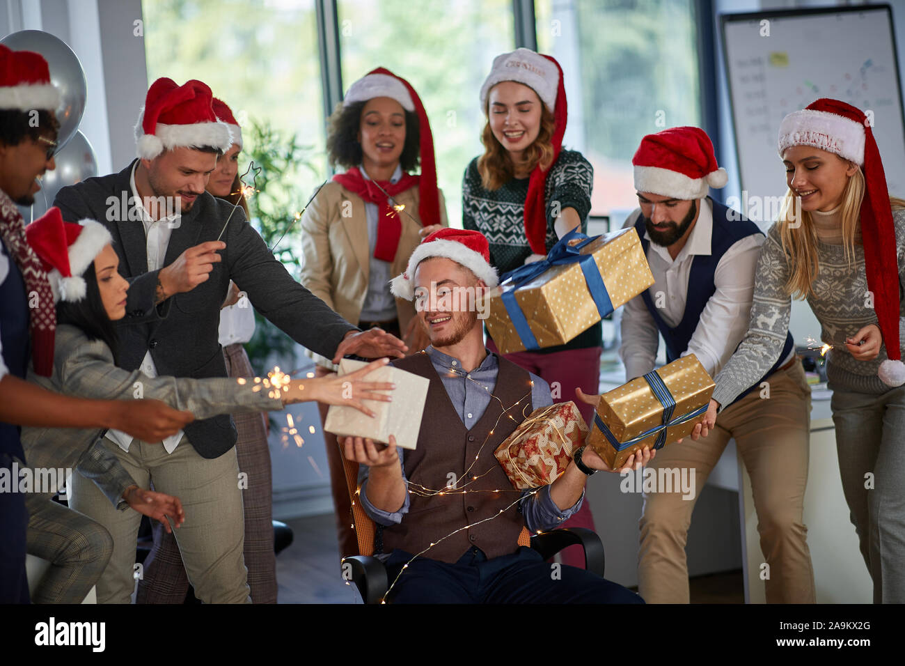 Felice la gente di affari in santa con cappello di Natale presente al partito azienda celebrando vacanza insieme . Foto Stock