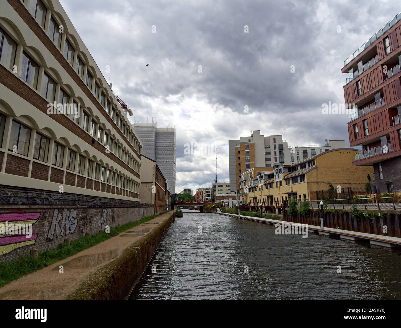 Vista lungo il Limehouse tagliare canal con nuovi sviluppi residenziali in un post-zona industriale (Limehouse, Londra, Regno Unito). Dopo la pioggia. Foto Stock