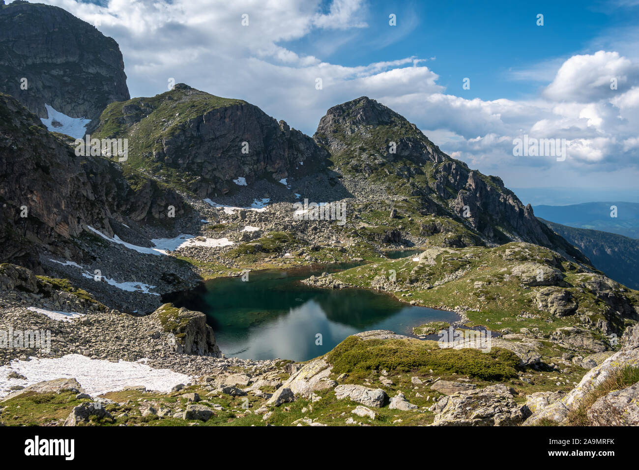 Vista sul lago Elenino sotto la cima di Malyovitsa in una giornata estiva soleggiata. Lago nel parco nazionale di Rila, la catena montuosa di Malyovitsa, Bulgaria. Foto Stock