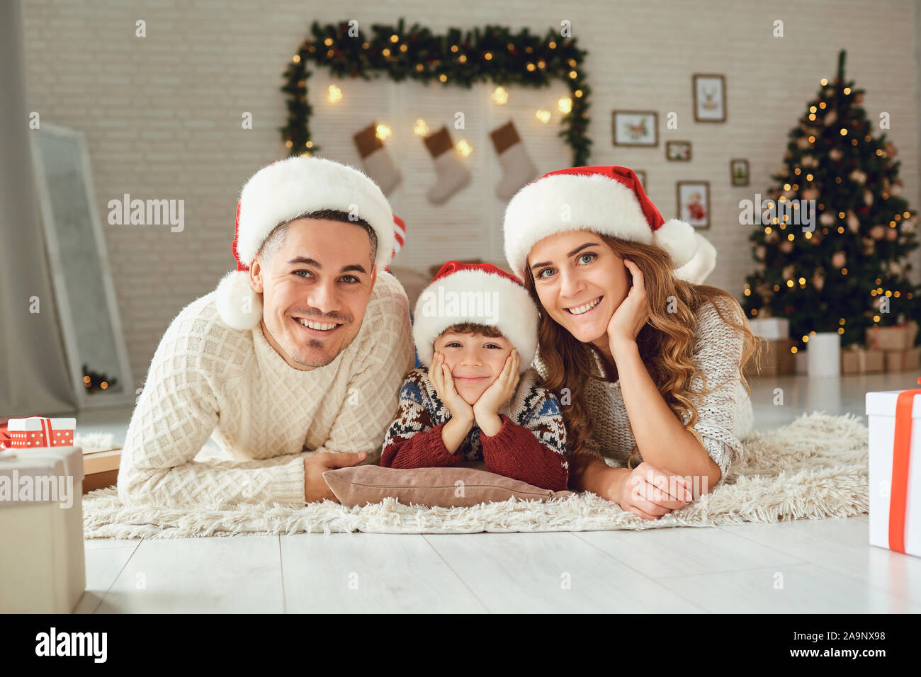 I genitori con il loro figlio in una stanza a Natale Foto Stock