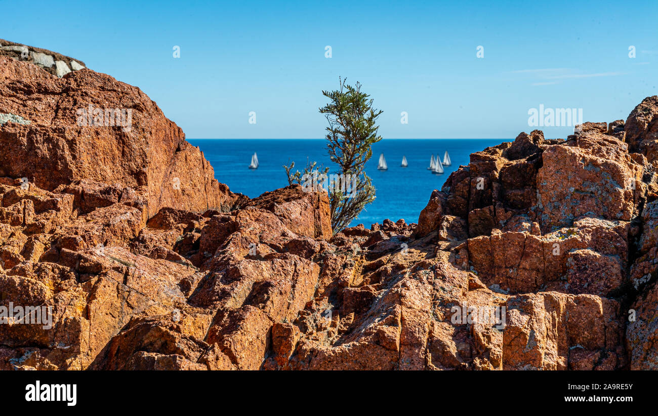 Cap roux sentiero escursionistico in rocce rosse delle montagne Esterel con il blu del mare del Mediterraneo Foto Stock