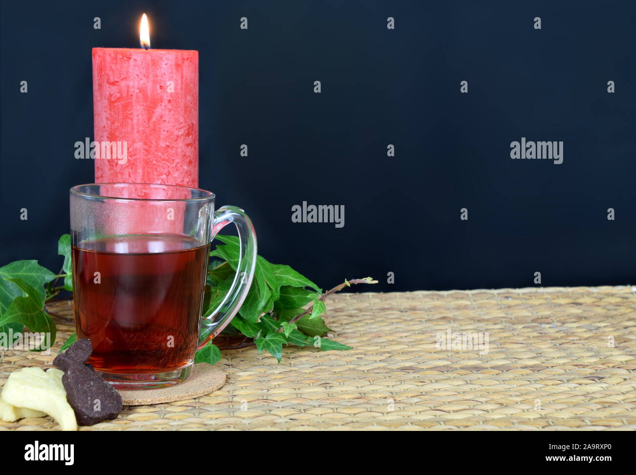 Rilassante con un tè caldo e un libro di sera Foto Stock