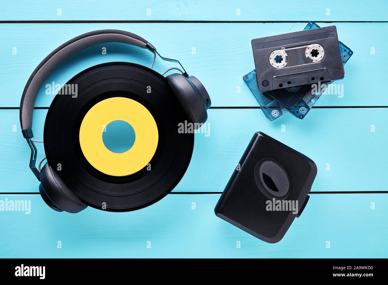 Annata record di vinile, cuffie, lettore di cassette e cassette su un tavolo di legno. Concetto di 80s di musica di ascolto audio. Foto Stock