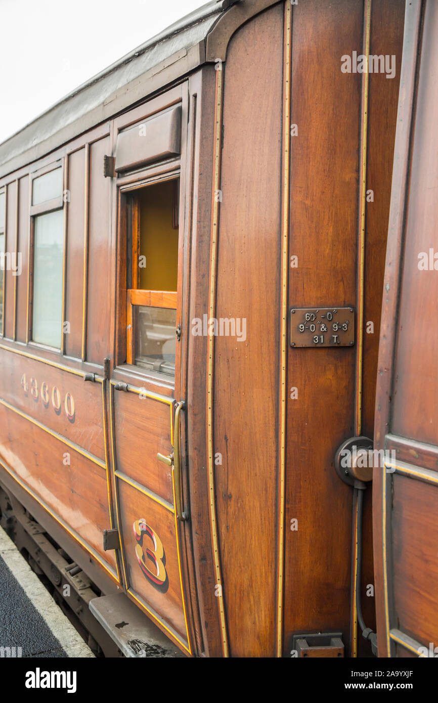 Primo piano, carrozza ferroviaria in teak UK accanto alla piattaforma alla stazione ferroviaria vintage di Kidderminster, Severn Valley Heritage Steam Railway. Foto Stock
